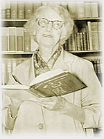 Photo of Dorothea Mitchell holding her book, Lady Lumberjack.